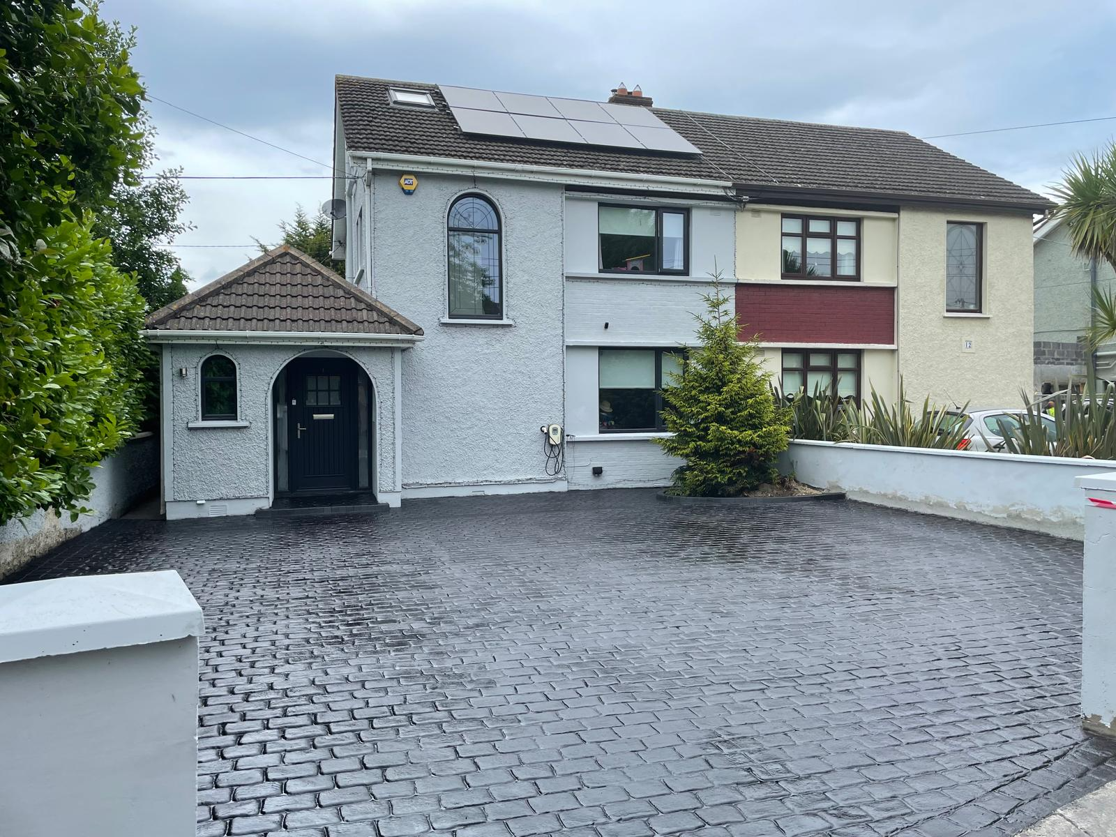 Stylish stamped concrete driveway mimicking natural stone by Concrete Driveways Dublin